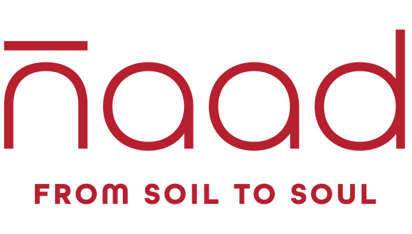 The logo for 'naad' featuring the brand name in a red stylized font with a horizontal bar over the 'n', and the tagline 'FROM SOIL TO SOUL' underneath, centered on a plain white background.